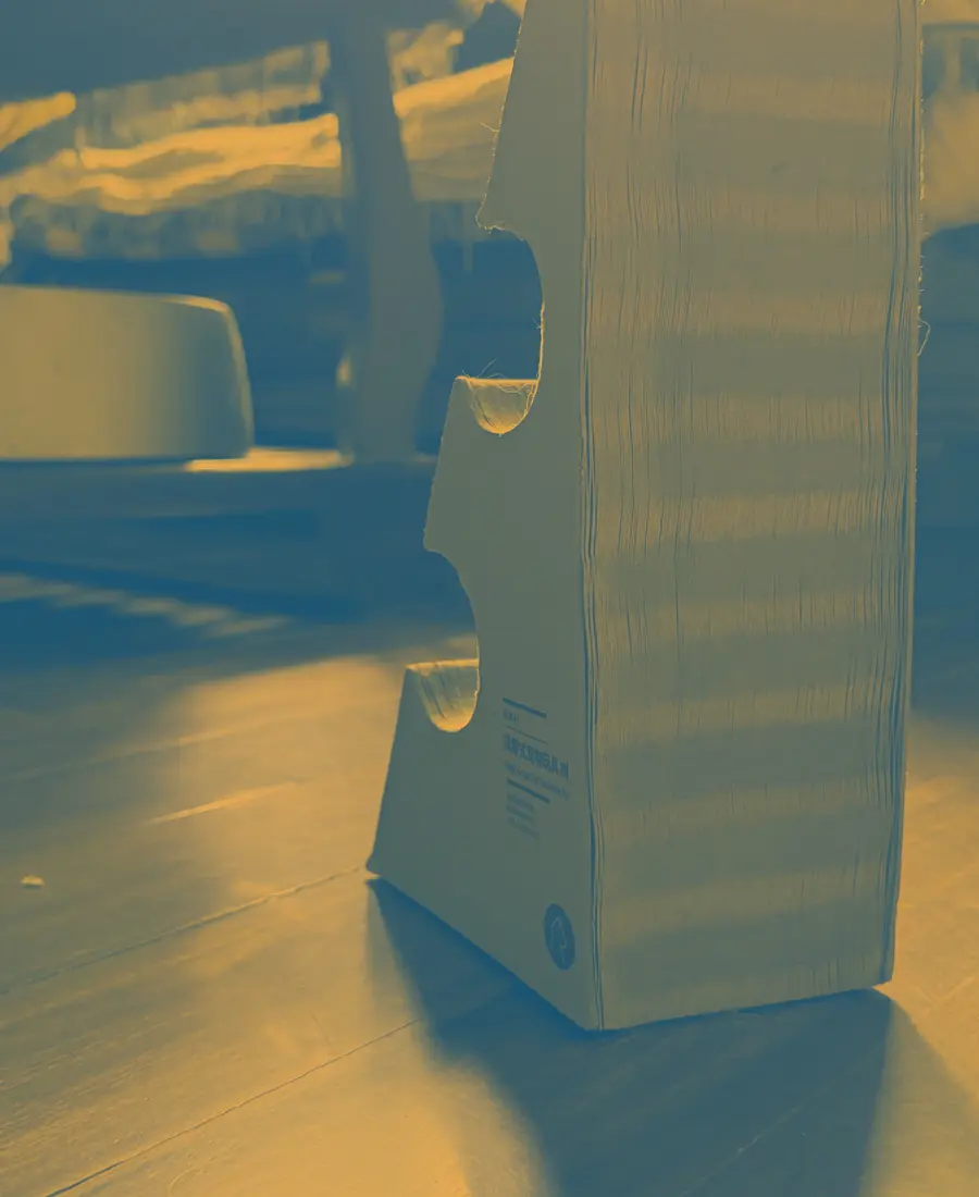 A cardboard cat scratcher standing on the floor
