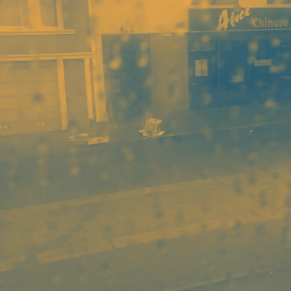 A rainy street seen through a window
